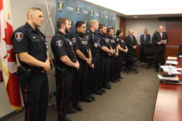 Windsor Mayor Drew Dilkens (far right) publicly recognizes seven Windsor police officers at a Windsor Police Board meeting, June 2, 2015. (Photo by Mike Vlasveld)
