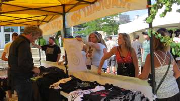 A Tragically Hip fan eyes some band merchandise. (Photo by Miranda Chant, Blackburn News)