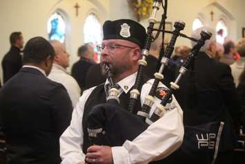 A Windsor Police bagpiper plays 