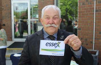 Essex Mayor Ron McDermott holds up a mini version of his towns new flag, May 13, 2015. (Photo by Mike Vlasveld)