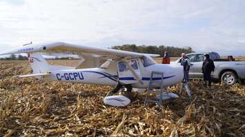 Windsor Flight Club members, including John Cundle, work to take the wings off the aircraft that made an emergency landing in Sarnia last week. October 31, 2017 (Photo by Melanie Irwin)