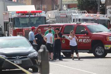 Bystanders watch as fire crews tackle a blaze at the Olde Walkerville Theatre in Windsor, September 1, 2018. Photo by Mark Brown/Blackburn News.