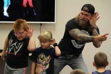 Cody Deaner, and two fans reinact poses from Hulk Hogan during a presentation on Thursday. Photo by Michael Hugall) 