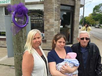 (Left to right) Sarnia-Lambton MADD President Natalie Leduc joins Kim MacIntosh, baby Paige and Ralph MacIntosh to place purple ribbons at Mitton and George St. May 24, 2017 (Photo by Melanie Irwin) 