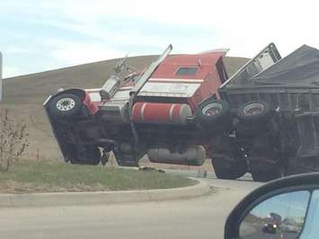 A tractor trailer flips over at the roundabout at Hwy. 3 and Hwy. 401, April 14, 2015. (Photo courtesy of Trish Longson)