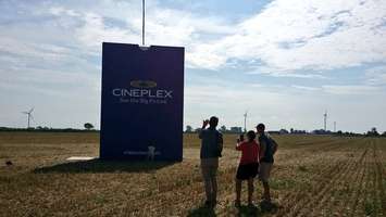 Residents check out a giant bag of popcorn Cineplex put up on Queen's Line, August 25, 2016 (Photo by Jake Kislinsky)
