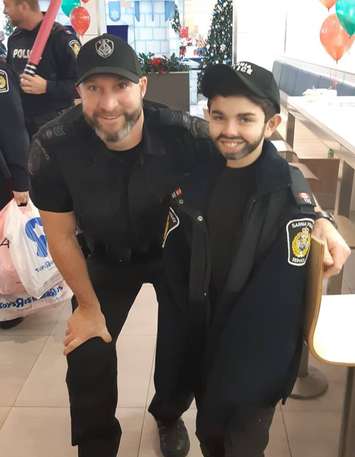Sgt. Mike VanSickle with a young impersonator. December 5, 2018. (Photo by the Sarnia Police Service)