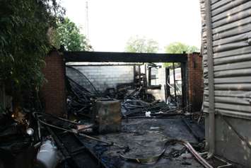 Fire destroyed a garage and damaged the rear of a home on Camelot Cres. July 7, 2015 (BlackburnNews.com photo by Dave Dentinger)
