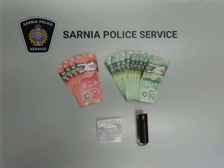 Cash and mace seized by Sarnia Police Service - Aug 22/24 (Photo courtesy of Sarnia Police Service)