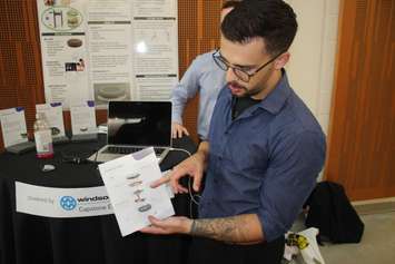 University of Windsor student Connor Holowachuk shows how his group is developing wearables through inertial measurement units at the U of W Lumley Centre for Engineering Innovation, July 26, 2019. Photo by Mark Brown/Blackburn News. 
