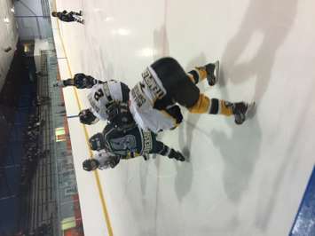 Mitchell and Twin-Centre players battle in the corner during their  Novice 