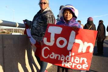Supporters come out to the Communications Rd. overpass on Hwy. 401 for the repatriation ceremony of fallen veteran and Wheatley native John Gallagher on November 20, 2015. (Photo by Ricardo Veneza)