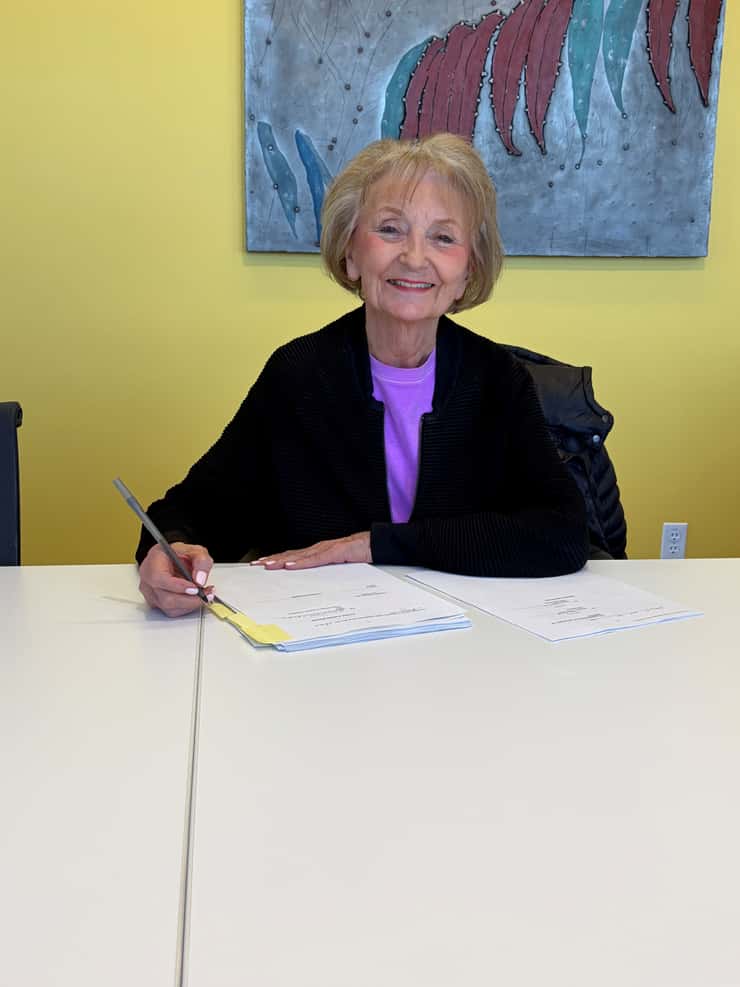 Allison Richards, owner and founder of Stones 'N Bones Museum, signs the donation agreement finalizing the donation of 4,650 items to the County of Lambton. Photo courtesy of the County of Lambton.