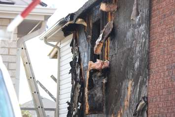 Fire investigators comb through a house on Spago Cres. after a weekend blaze, March 30, 2015. (Photo by Jason Viau)