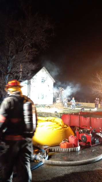 Firefighters battle a house fire on Road 5 W in Kingsville, March 10, 2016. (Photo courtesy of Bob Kissner via Twitter)