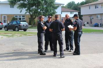 Chatham-Kent firefighters discussing their plans during the post fire reassurance initiative. September 6, 2016. (Photo by Natalia Vega)