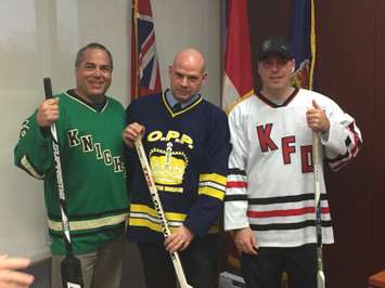 L-R: Peter Wolfe, KDSS Hockey Coach, Detective Constable Dave Hackney of South-Bruce OPP, and Mike Drake, acting captain for the Kincardine Fire Department, pose with hockey sticks at the unveiling for the Push For Change Hockey Challenge Kincardine event. January 19th, 2017. (Photo by Ryan Drury)