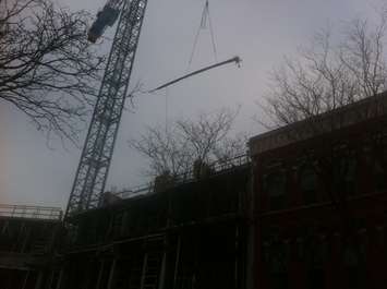 Workers unload a shipment of rebar at the downtown Chatham condo project site on January 23, 2015. (Photo by Mike James)