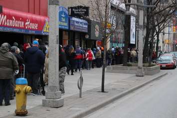 People in need line up along Ouellette Ave. in Windsor in hopes of receiving one of 500 turkeys being given away, December 17, 2014. (photo by Mike Vlasveld)