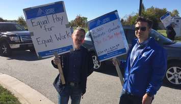 (Left to Right) Shahram Karimi; Professor & NSERC Industrial Research Chair Alternative Energy Engineering Technology  and Alan Warren; Coordinator of Mathematics and Physics picket at the entrance to Lambton College. October 18, 2017 (Photo by Melanie Irwin)