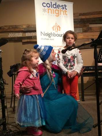 Cami Moore (center) and two kids singing 