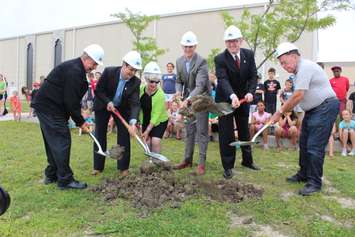 Four Windsor City Councillors, Windsor Mayor Drew Dilkens and a representative from DeAngelis Construction dig up ground where the new addition to the WFCU Centre will be built, July 7, 2015. (Photo by Mike Vlasveld)