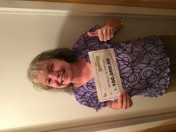 Michele Lussier of Windsor shows off her $100,000 cheque after winning on OLGs Instant Crossword Tripler game. Photo submitted by Ontario Lottery and Gaming.