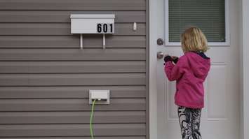 Liegha opens the door to her new Habitat for Humanity home, which she will share with her grandmother Anne LaForge. October 24, 2019 Photo by Melanie Irwin.