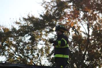 A firefighter at the scene of a fire at a restaurant at Wyandotte St. E and Marion Ave. in Windsor, October 12, 2015.  (Photo by Adelle Loiselle)