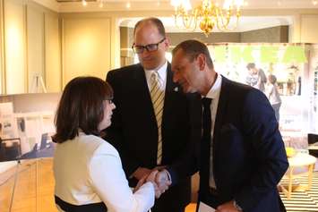 Windsor Mayor Drew Dilkens looks on as President of IKEA Canada Stefan Sjostrand shakes the hand of Executive Director of Windsor Family Services Joyce Zuk at Willistead Manor, October 14, 2015. (Photo by Mike Vlasveld)