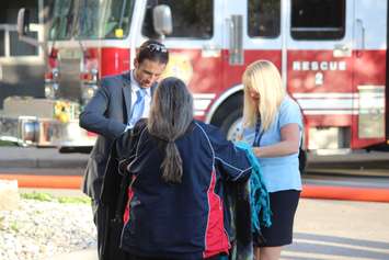 Residents distribute blankets after a fire at an apartment building on Rivard Ave. in Windsor, October 7, 2015.  (Photo by Adelle Loiselle)