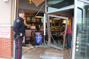 Officials deal with the fallout after a car smashed through a coffee shop on Dougall Ave. in Windsor on March 30, 2016. (Photo by Ricardo Veneza)