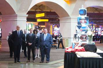 Windsor Mayor Drew Dilkens, left; Kevin Laforet of Caesars Entertainment and Gordon Orr of TWEPI stand near a large cake display at the Caesars Windsor 25th-anniversary kickoff on May 14, 2019. Photo by Mark Brown/Blackburn News.