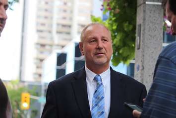 DWBIA Chair Larry Horwitz uses the backdrop of downtown Windsor to announce his bid to be the Conservative candidate in Windsor West on August 5, 2015. (Photo by Ricardo Veneza)