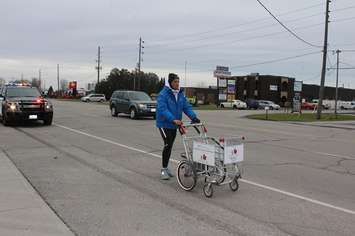 Joe Roberts walking into Chatham, pushing a shopping cart in his Push for Change campaign. November 28, 2016. (Photo by Natalia Vega)