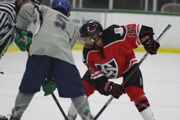 Lucas Vanroboys (red and black) lines up to take a faceoff. (Photo courtesy of Gina Vanroboys)