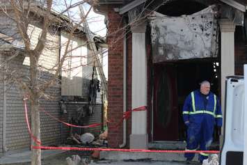 Fire investigators comb through a house on Spago Cres. after a weekend blaze, March 30, 2015. (Photo by Jason Viau)