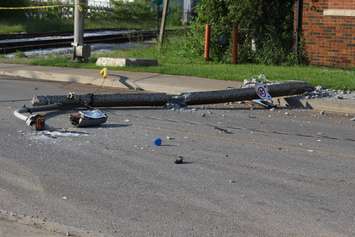 A truck knocks down two hydro poles and smashes through a fence on Drouillard just north of Franklin St., June 10, 2015. (Photo by Jason Viau)