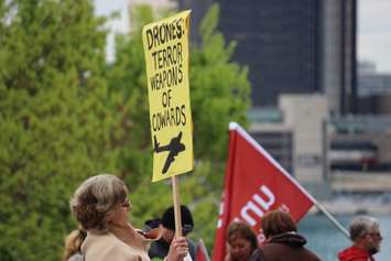 Protesters gather outside the Waterfront Hotel in downtown Windsor during Prime Minister Stephen Harper's visit to the city, May 13, 2015. (Photo by Jason Viau)