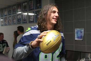 Seattle Seahawks Tight End Luke Willson presents St. Thomas of Villanova High School with a golden football, on behalf of the NFL, November 6, 2015. (Photo by Mike Vlasveld)