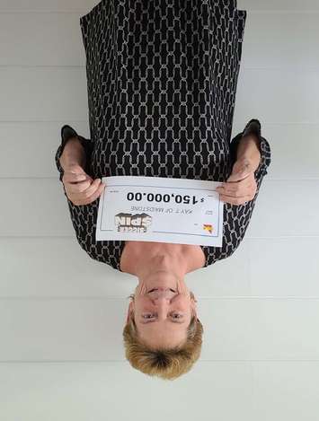 Kay Theaker of Tecumseh displays her winning Bigger Spin cheque at the OLG Prize Centre in Toronto, July 7, 2021. Photo provided by OLG.