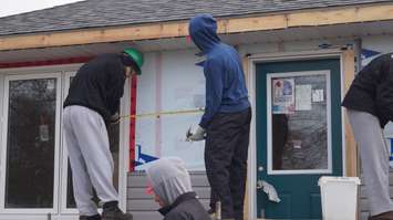 The Sarnia Sting helps with construction of Habitat for Humanity's latest build. December 2, 2014 (BlackburnNews.com photo by Jake Jeffrey)
