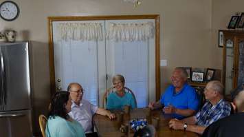 Ontario PC Leader Doug Ford and Sarnia-Lambton MPP Bob Bailey sit with the Reid family at their farm in Plympton-Wyoming. May 30, 2018. (Photo by Colin Gowdy, BlackburnNews)