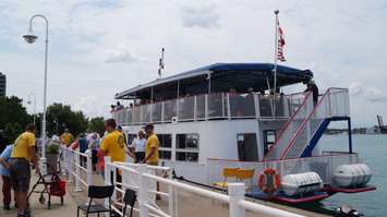 Firefighters and Duc D'Orleans crew members help residents aboard the Seniors Cruise June 29, 2015 (BlackburnNews.com Photo by Briana Carnegie)