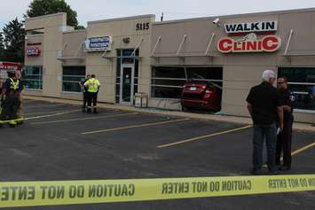 Emergency crews respond to a walk-in clinic on Tecumseh Rd. E after a car smashes through the front window, June 8, 2015. (Photo by Jason Viau)