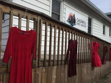 Red dresses hang outside the Caldwell First Nation office in Leamington on May 20, 2015. (Photo by Ricardo Veneza)