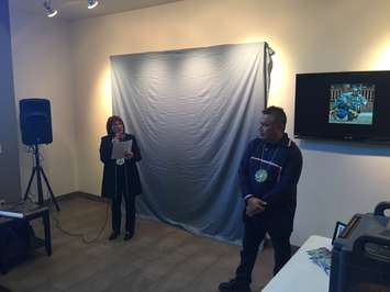 Aamjiwnaang Chief Joanne Rogers helps artist John Williams unveil his painting titled 