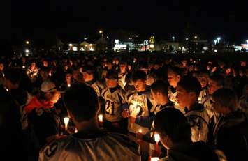 Teammates, friends and family of Michael Matte gather outside of General Amherst High School for a candlelight vigil, November 10, 2014. (photo by Mike Vlasveld)