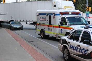 Windsor police investigate a crash involving a transport and a car on Riverside Dr. E and Walker Rd., August 5, 2015. (Photo by Jason Viau)