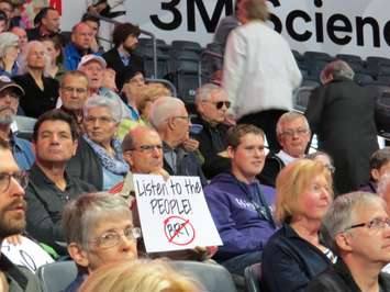 A London resident hold up a sign against the proposed BRT system at a public meeting at Budweiser Gardens, May 3, 2017. (Photo by Miranda Chant, Blackburn News)